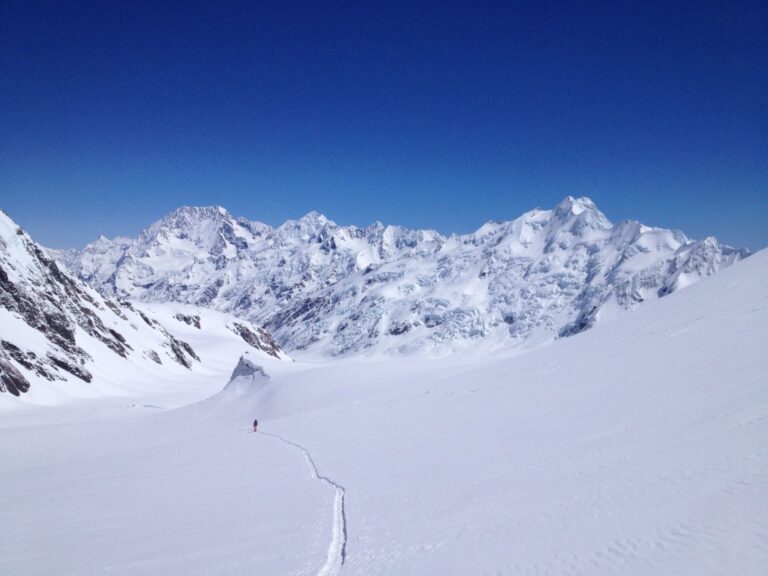 Ski touring on the Tasman Glacier with the Southern Alps in the background