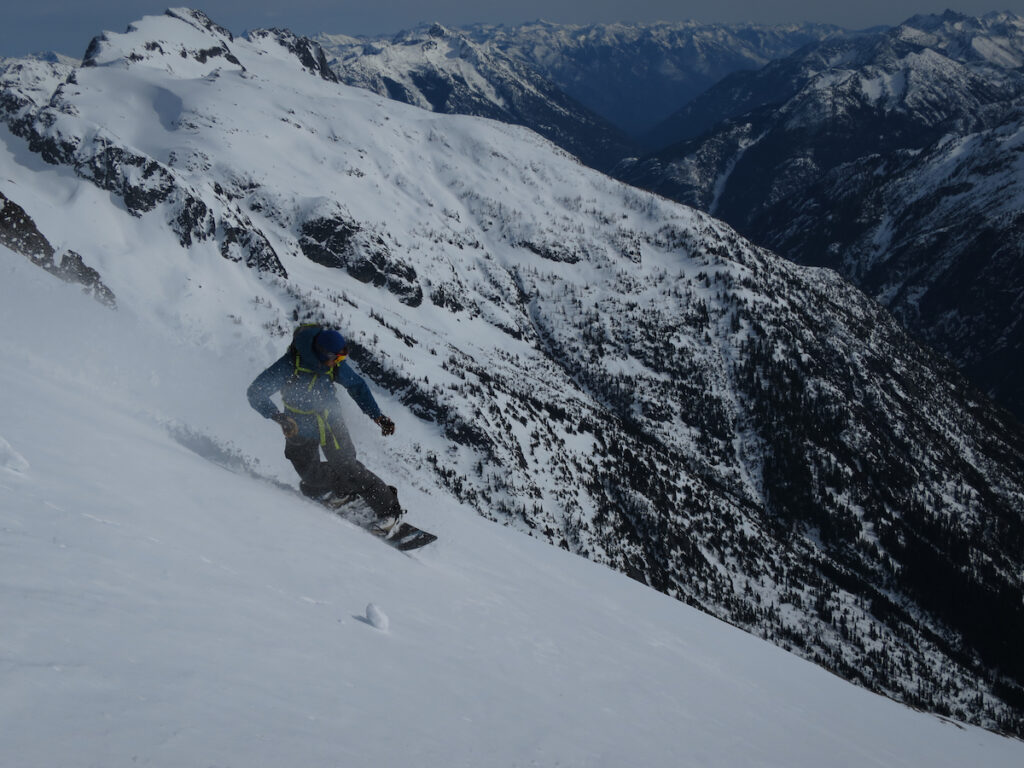 Snowboarding off the summit of Sahale Mountain