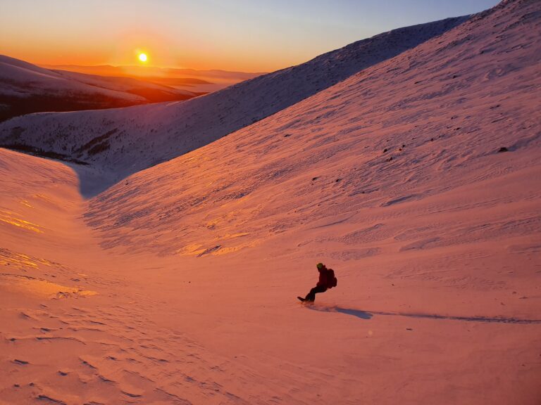 Ben snowboarding into the sunset in the Khibiny Mountains of Russia