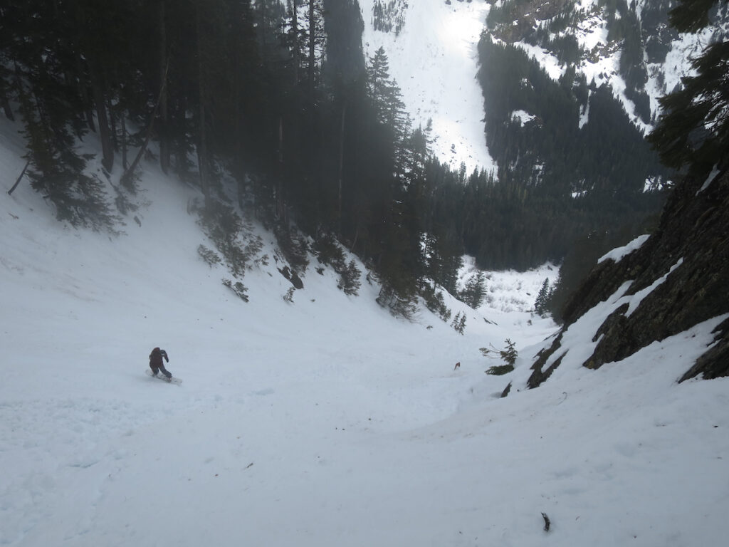 Snowboarding down to the Gold Creek Valley in one of the Kendall Peak Chutes in the Snoqualmie Pass backcountry