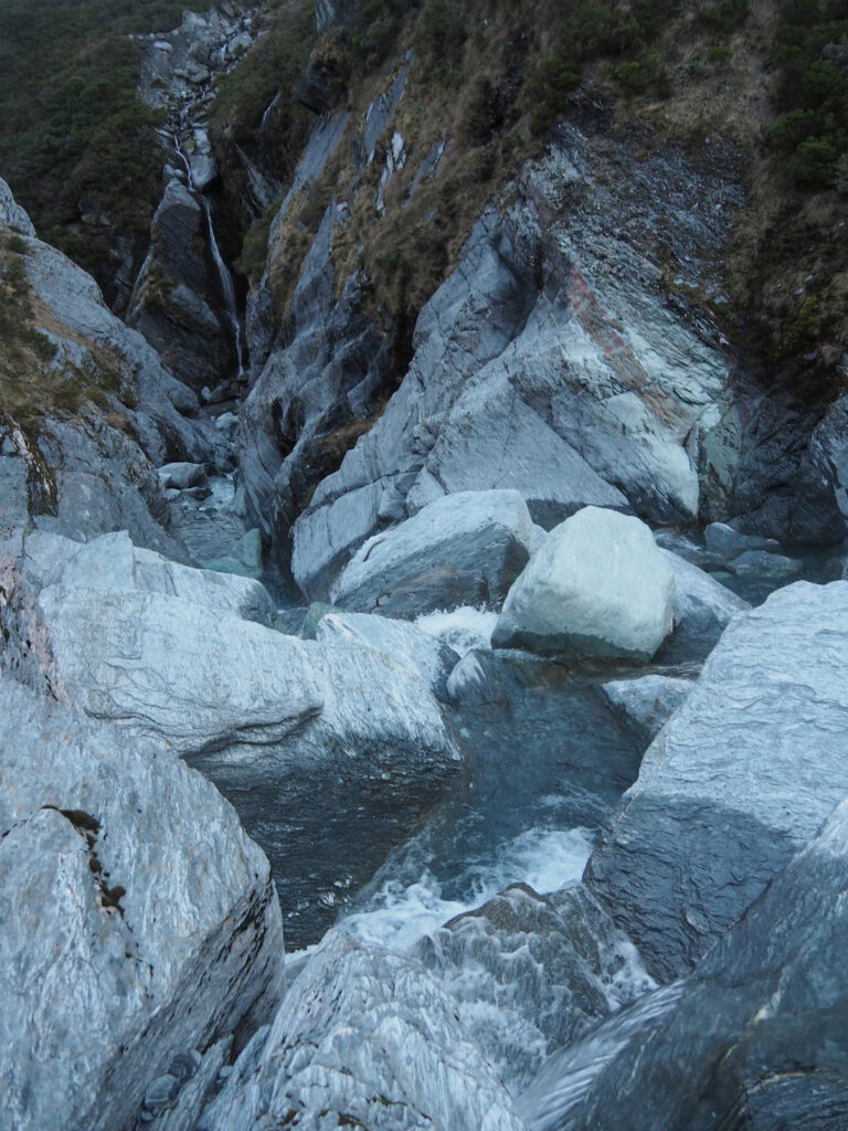 A stream filled with waterfalls below Mount Barff