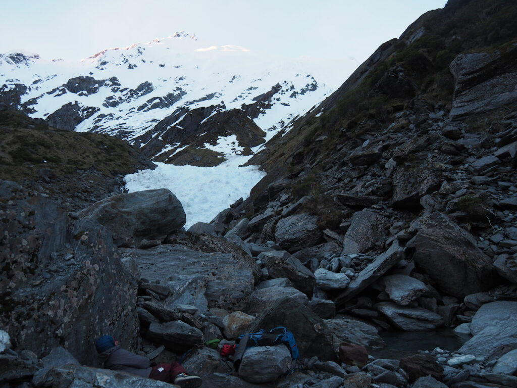 Camping under a rock with Mount Barff in the distance