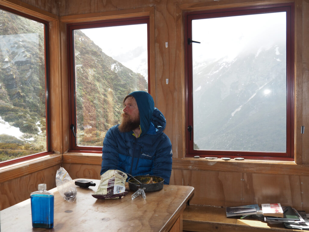 Waiting out a storm at the Liverpool Hut after climbing on Mount Barff