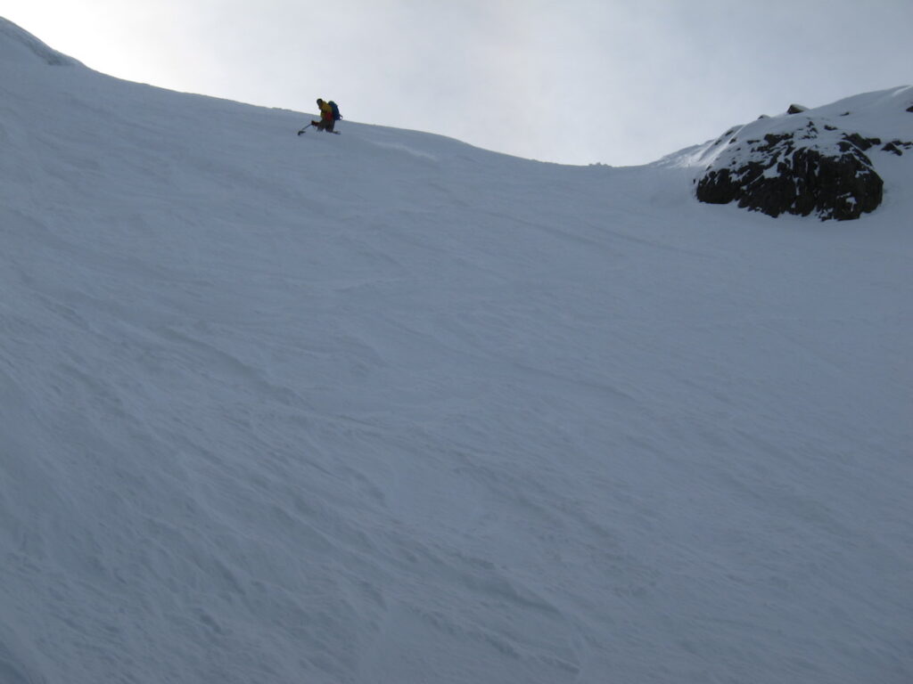 Snowboarding down the upper face of the Northwest Couloir on Mount Shuksan