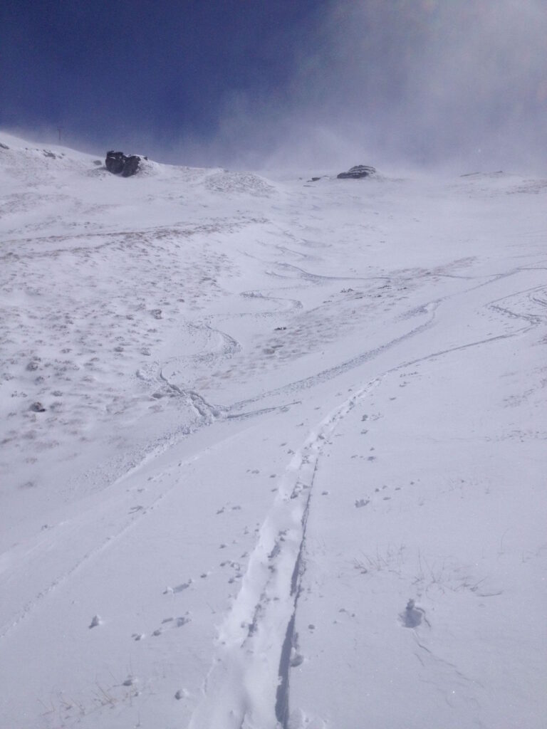 Riding the one strip of snow off the backside of Treble Cone