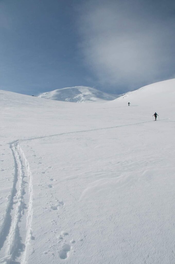 A switchback at a time making our way up the Emmons Glacier with the summit of Mount Rainier in the distance.