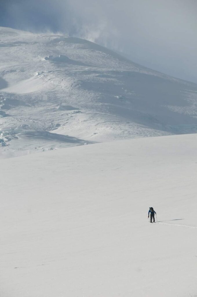 Battling the wind as we climb with the upper Emmons Glacier in view