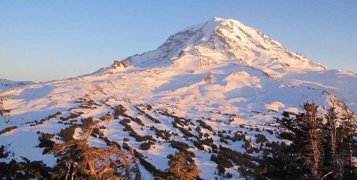 Morning alpenglow over Mount Rainier from Pleasant Peak in Winter