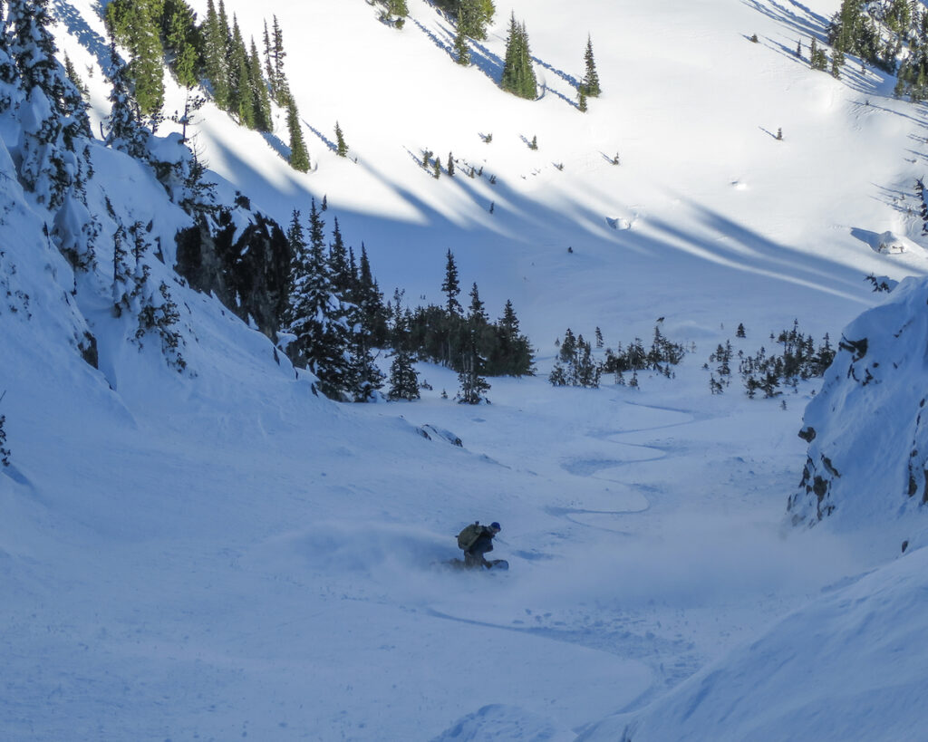 Perfect snowboarding turns in the Sheep Lake Couloir while ski touring the Crystal Mountain backcountry