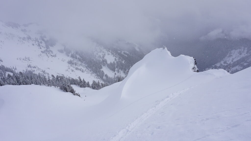 Looking down the south face of Castle Peak before riding to Butler Creek during the Tatoosh Traverse