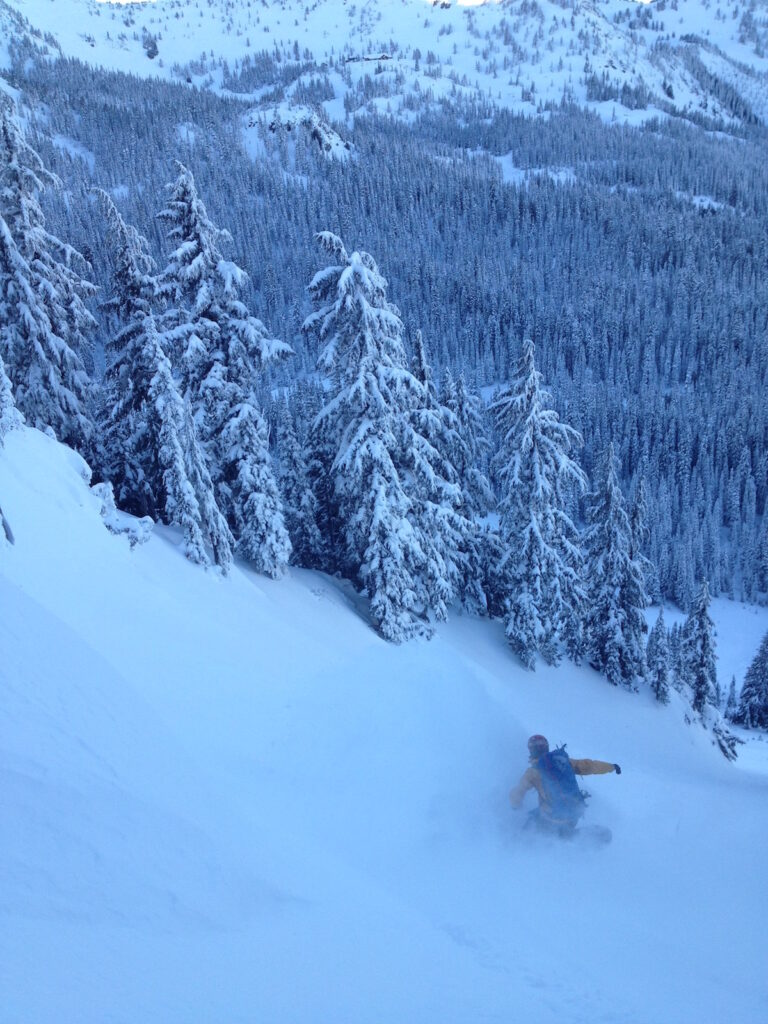 Snowboarding down the lower apron of the Dog Leg Chute