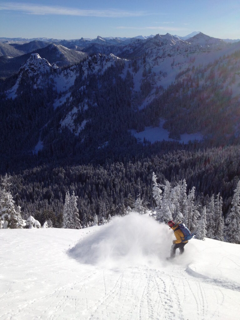 Snowboarding off the South side of Dogleg Peak in the Crystal Mountain backcountry