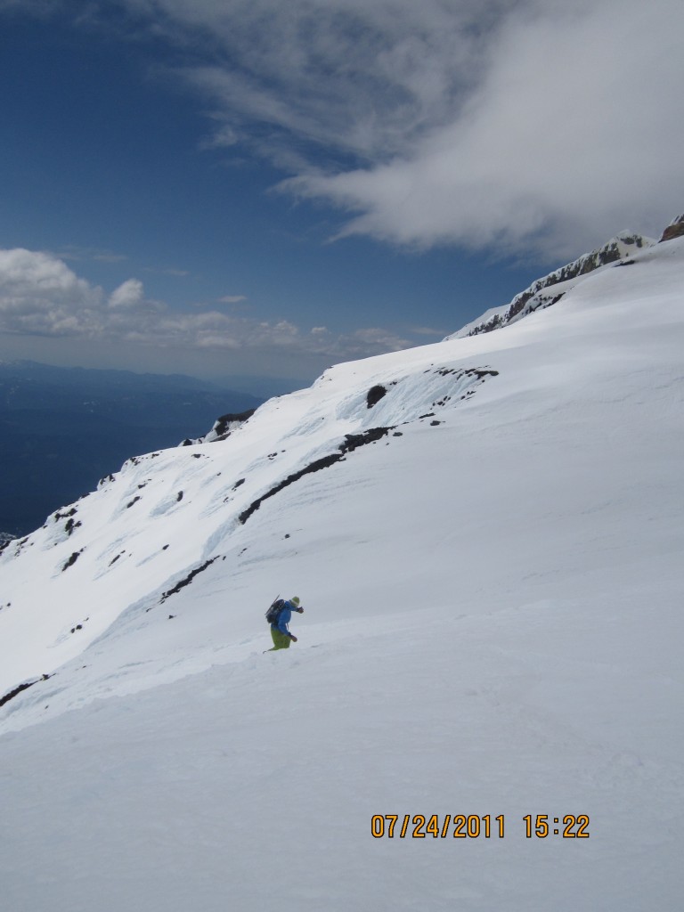 Dropping into the Avalanche Glacier headwall after snowboarding off the summit of Mount Adams