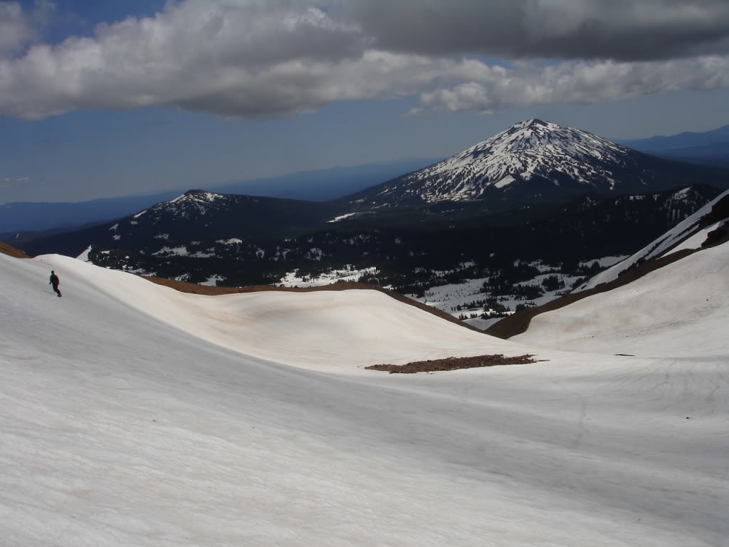 Snowboarding the north slopes of Broken Top with Mount Bachelor in the distance