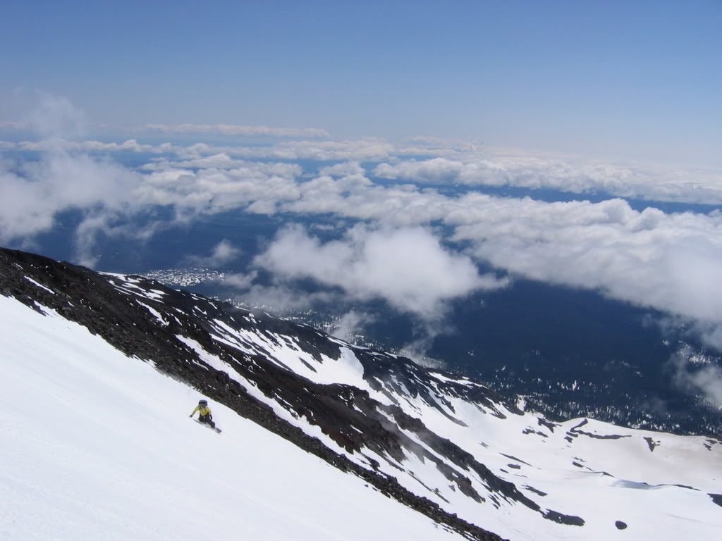 Snowboarding down the Southwest Chutes with the Oregon Cascades in the distance