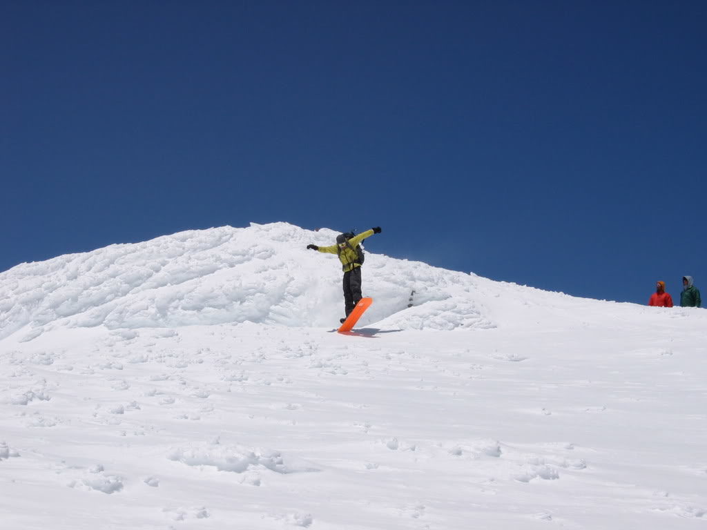 Making snowboard turns off the summit of Mount Adams