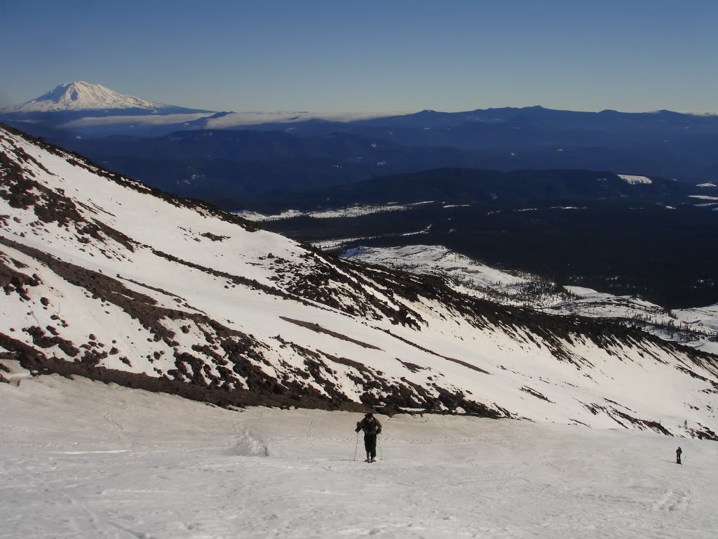 Ski touring up the lower slopes with Mount Adams in the distance