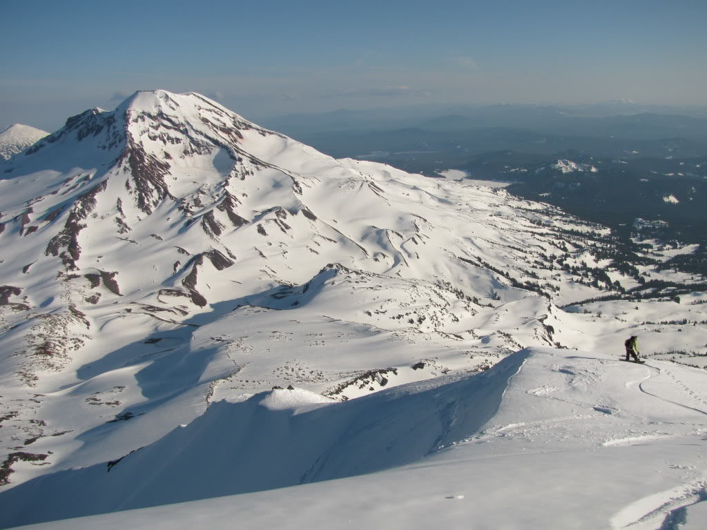 Snowboarding down the Middle Sister with the South Sister in the distance in Three Sisters Wilderness