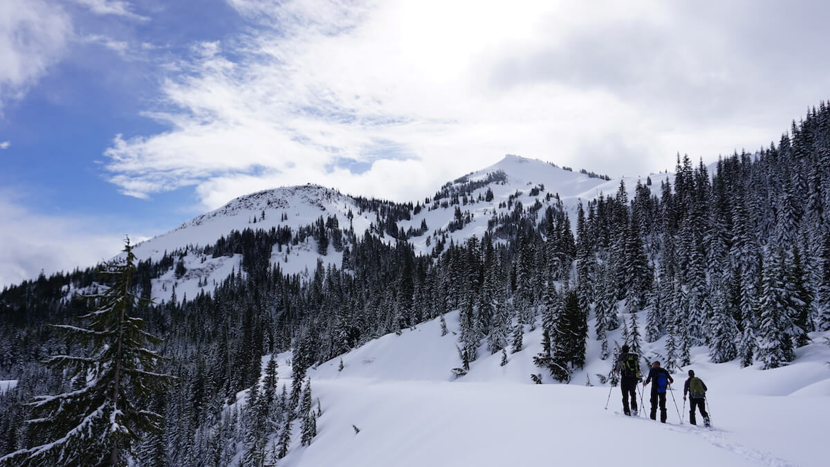 Ski touring out to the Tatoosh Range while heading into the backcountry of Mount Rainier National Park
