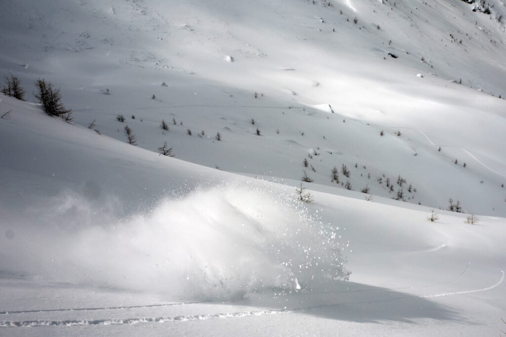 Snowboarding in powder conditions while riding down Geierschnabel Valsertal in Austria
