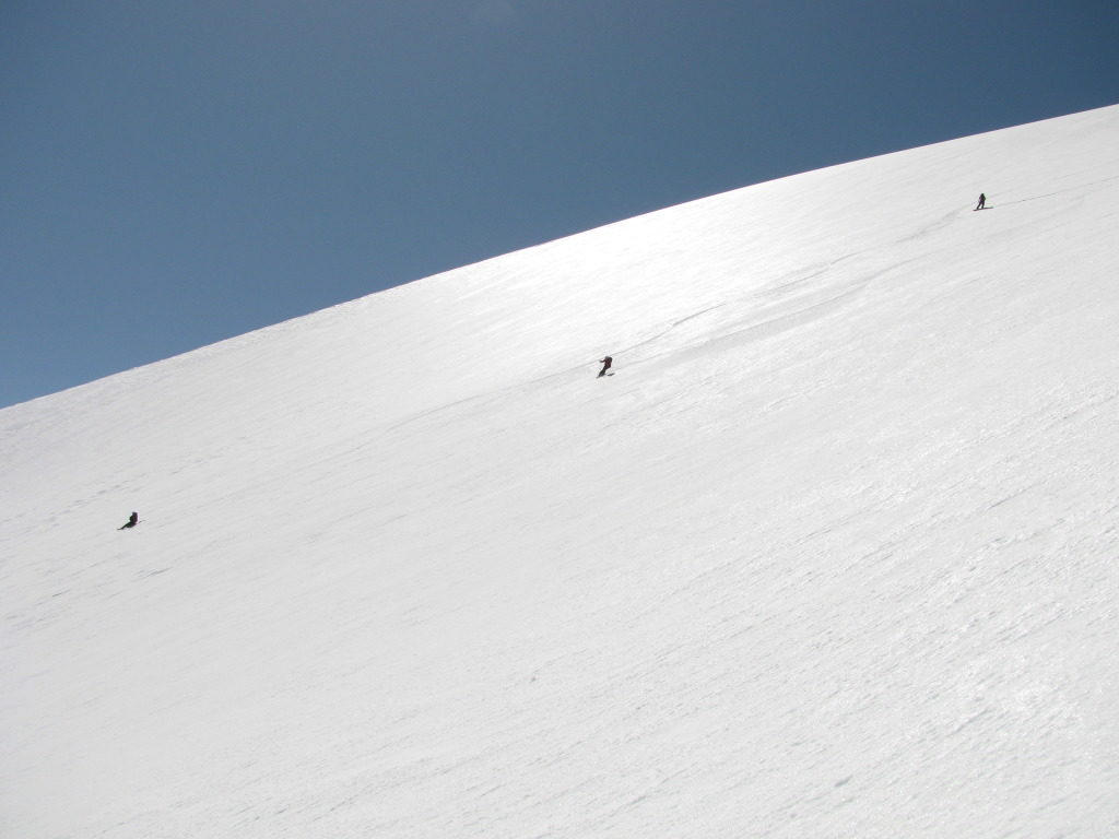 Making ski turns on the upper Konwakiton Glacier off the summit of Mount Shasta