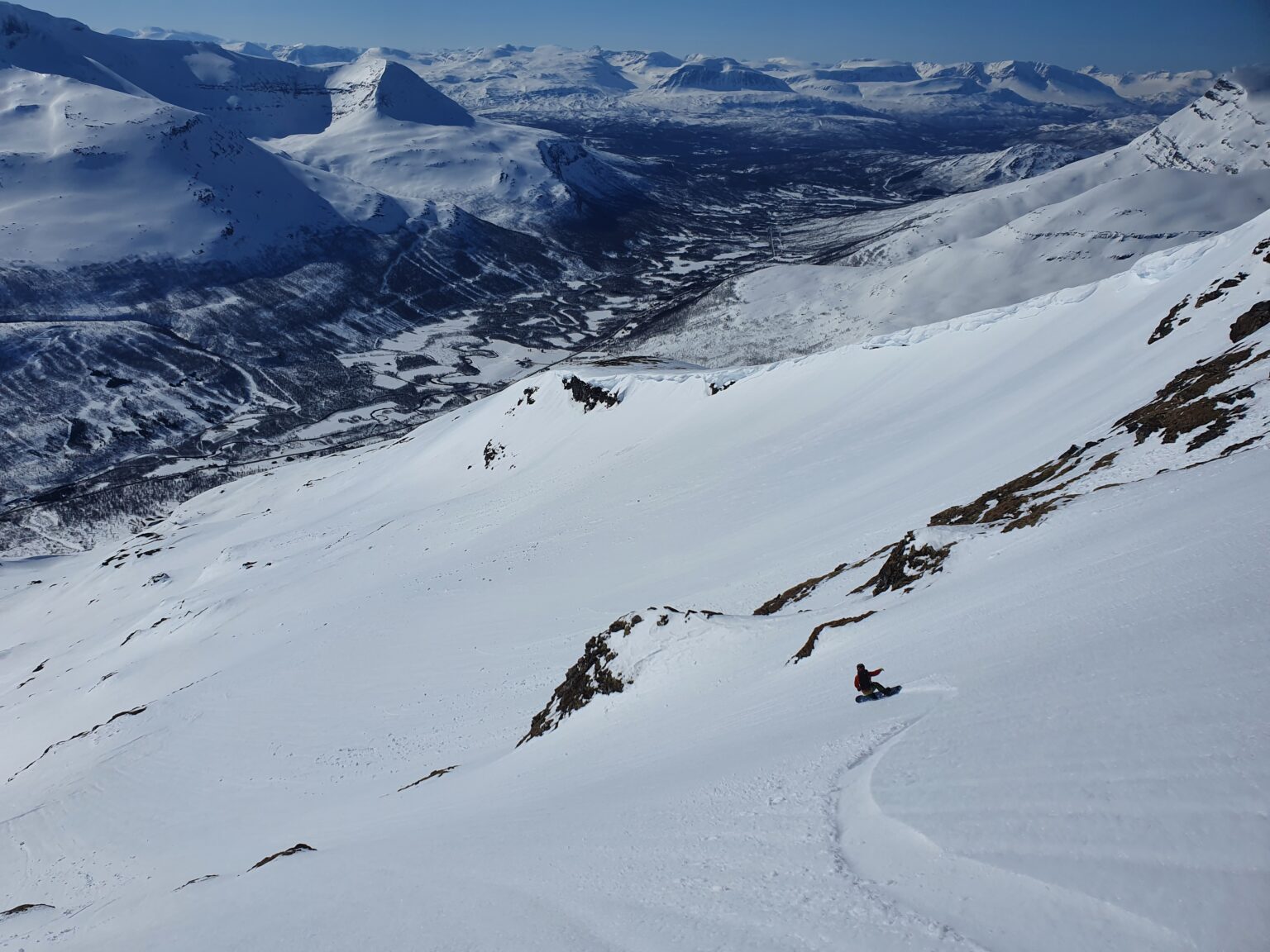 Snowboarding down the South Face of Blåbærfjellet in the Tamokdalen Backcountry of Northern Norway