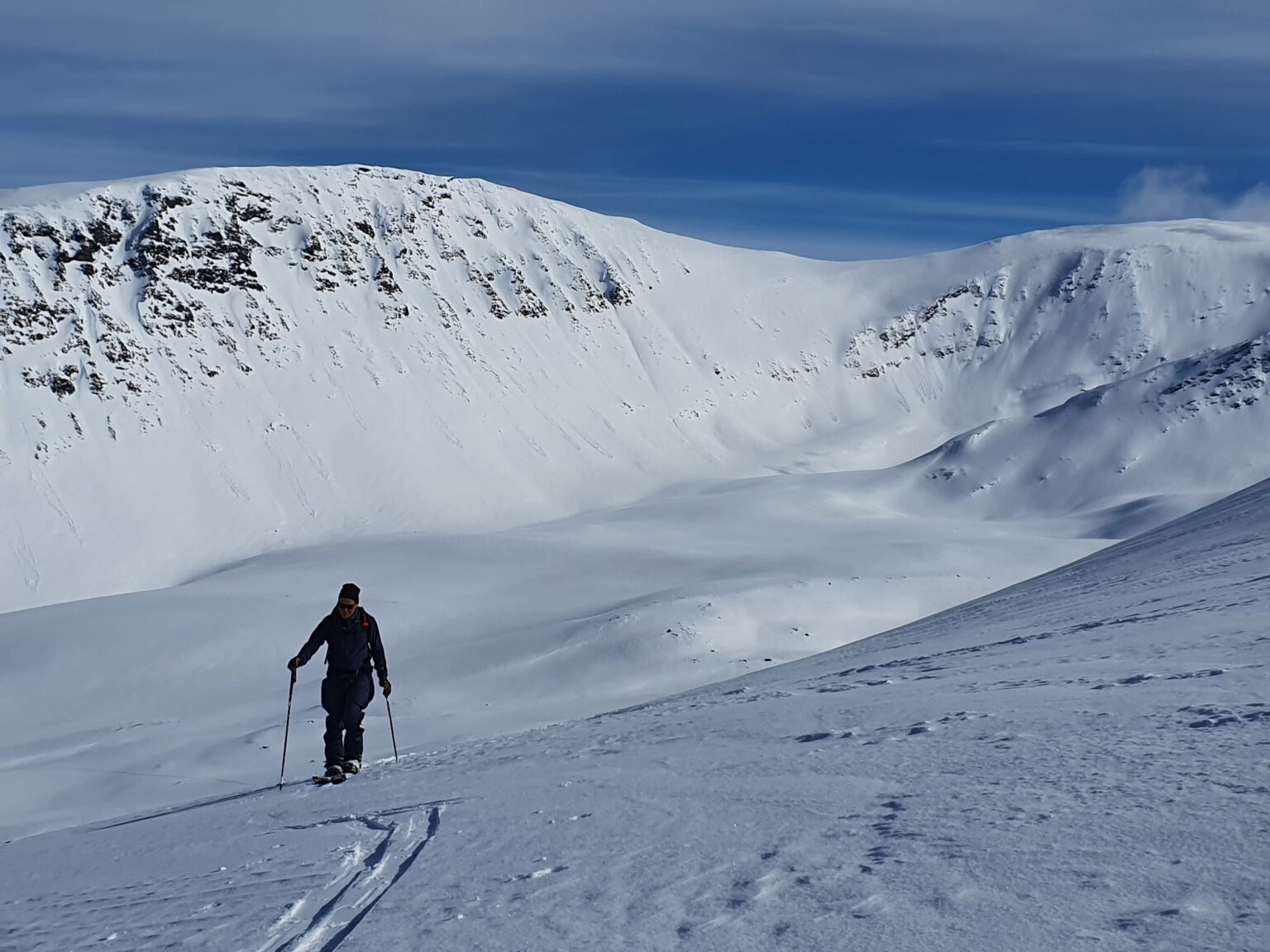Ski touring past the crux zone of Istinden with the Tamok Husset backyard in the background