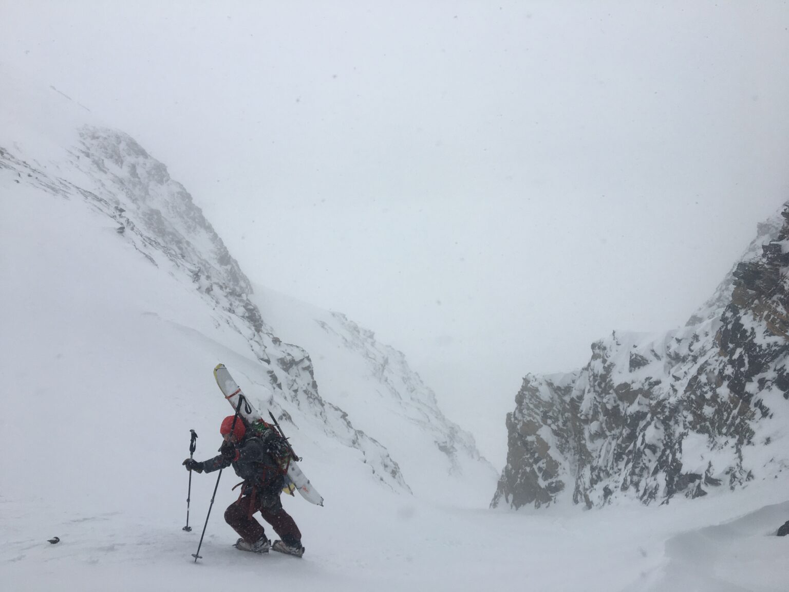 Climbing between rocks on the West chute of Rostafjellet in the Tamokdalen Backcountry