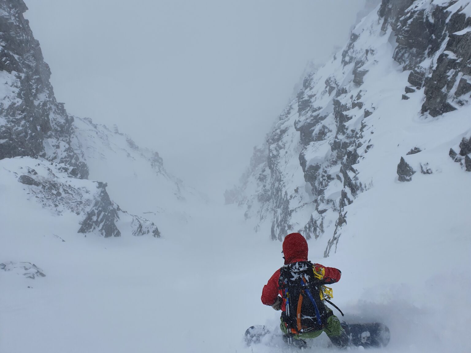 Snowboarding down the West Couloir of Rostafjellet in the Tamokdalen Backcountry