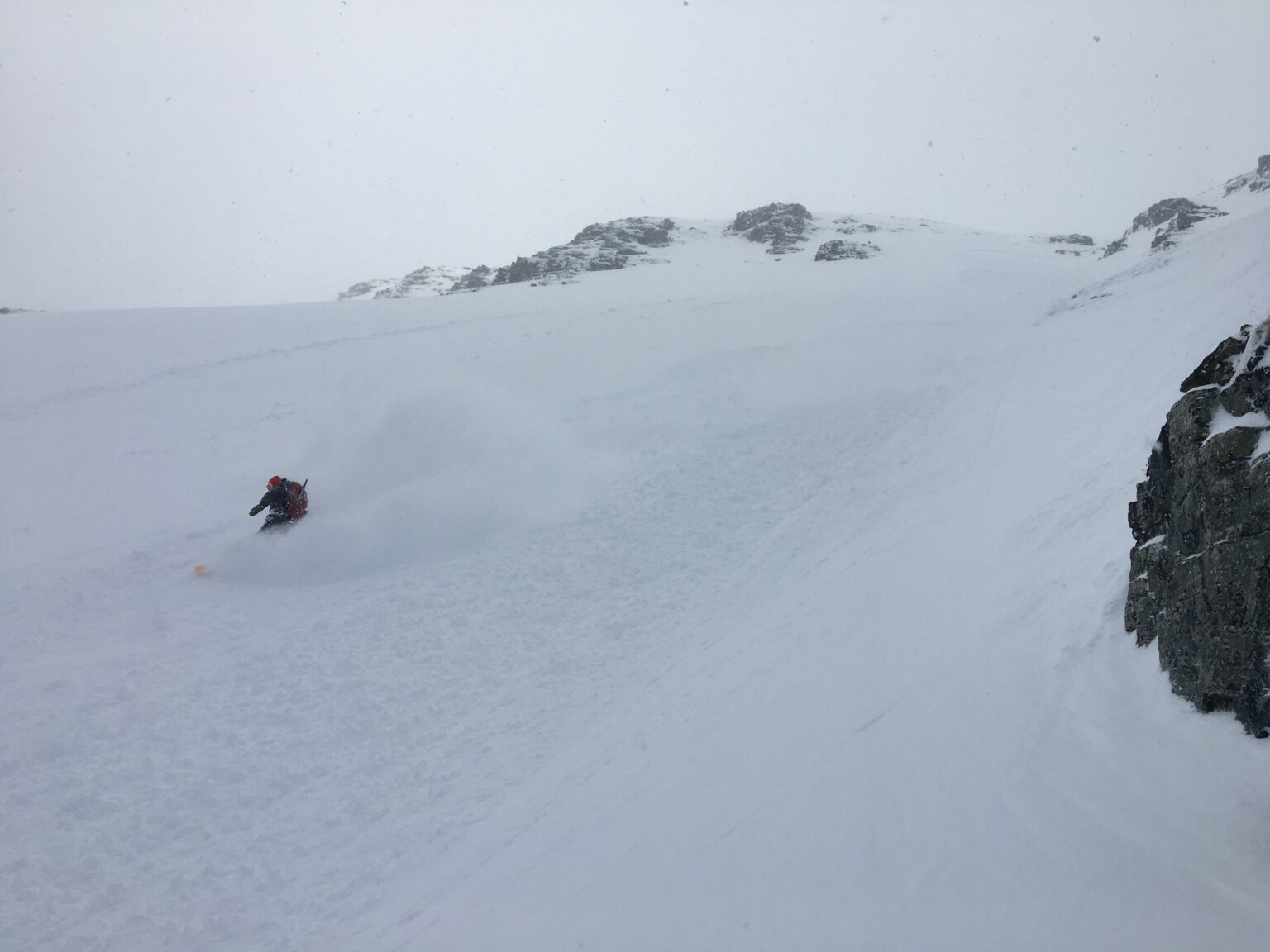 kicking up powder clouds on the West chute on Sjufjellet