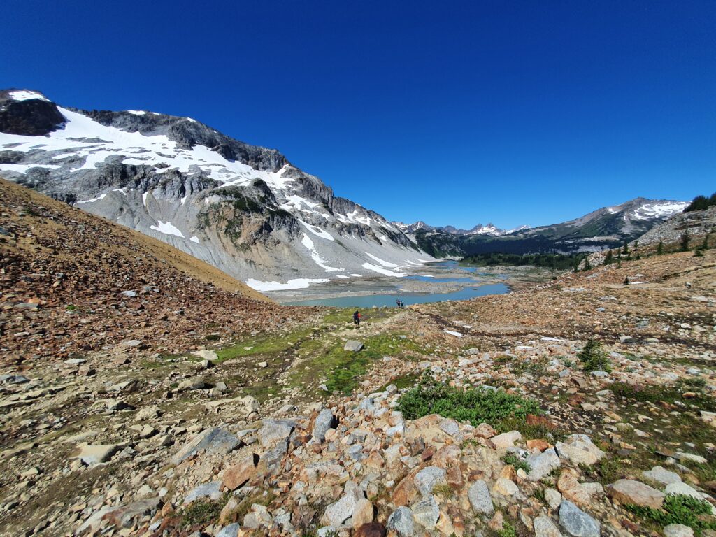 Hiking onto dry ground on the shores of Upper Lyman Lake