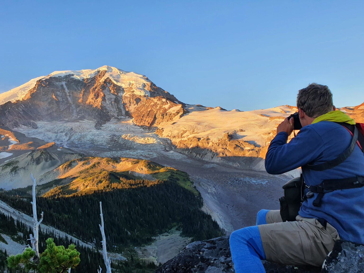 Jason Hummel taking a photo of Mount Rainier at sunrise