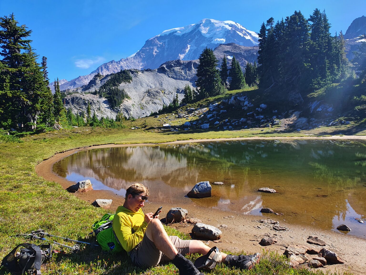 Checking out the topographical map while in Seattle Park with Mount Rainier in the background