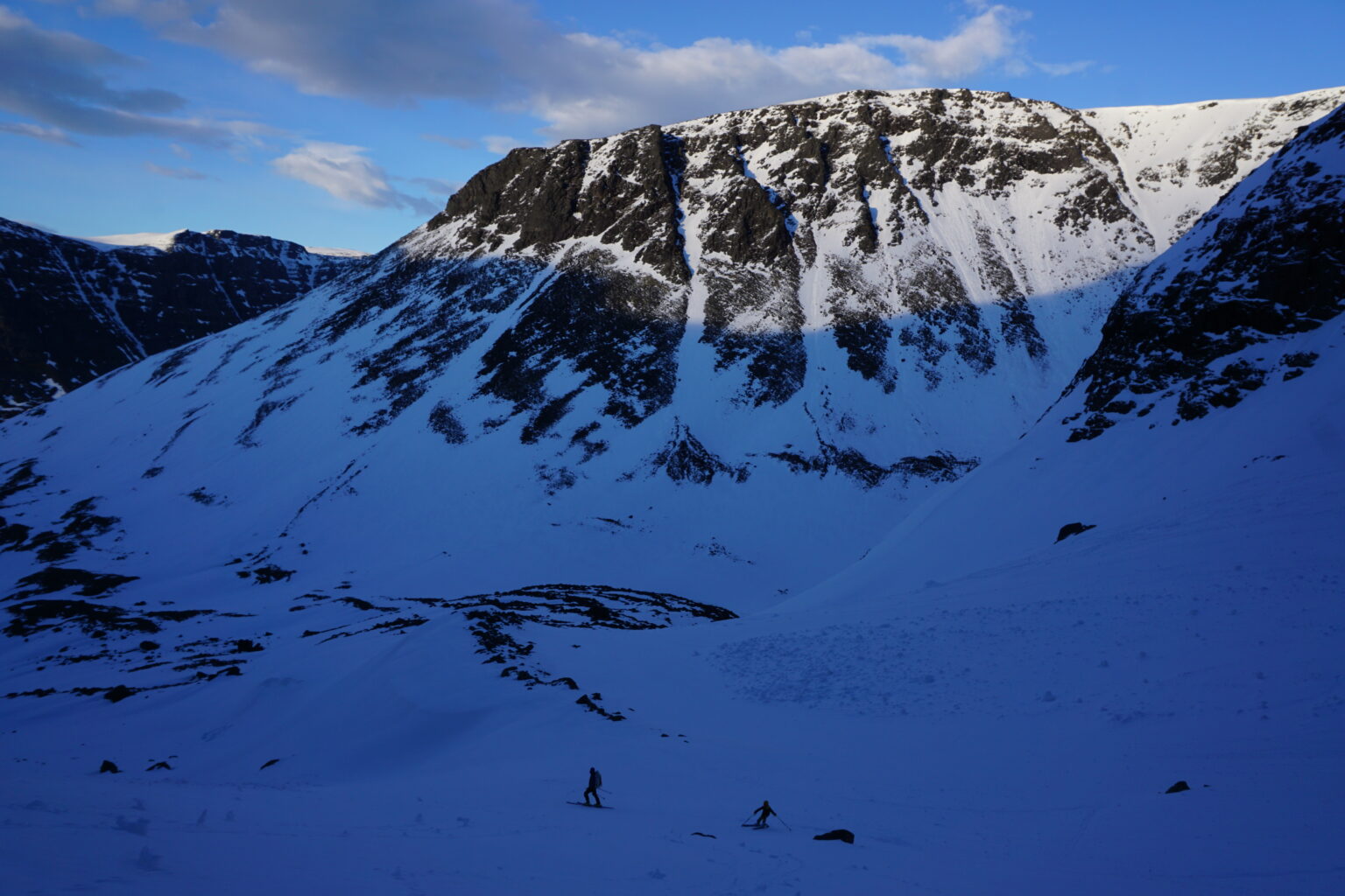 Skiing down the valley with the Southwest face of Sommarfjellet in the distance