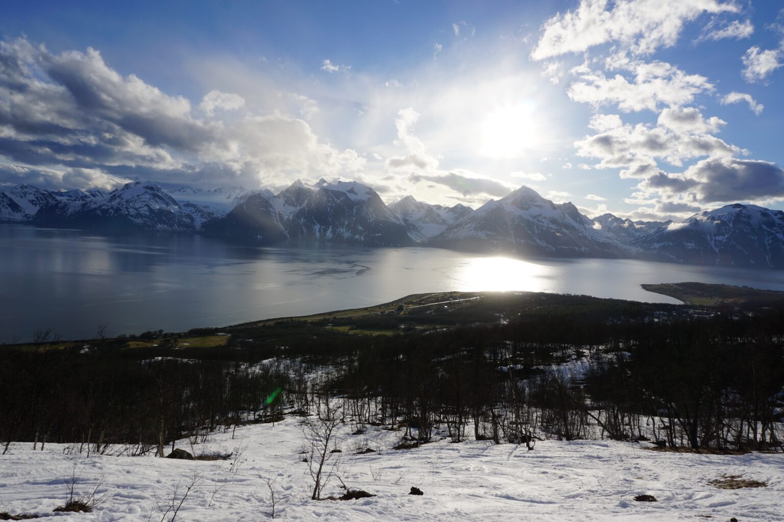 Ski touring up the base of Storhaugen with the Lyngen Alps in the background