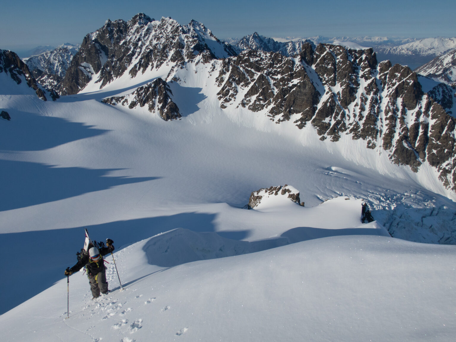 Climbing up the final pitch of Tvillingtinden with the Lyngen Alps of Norway in the background