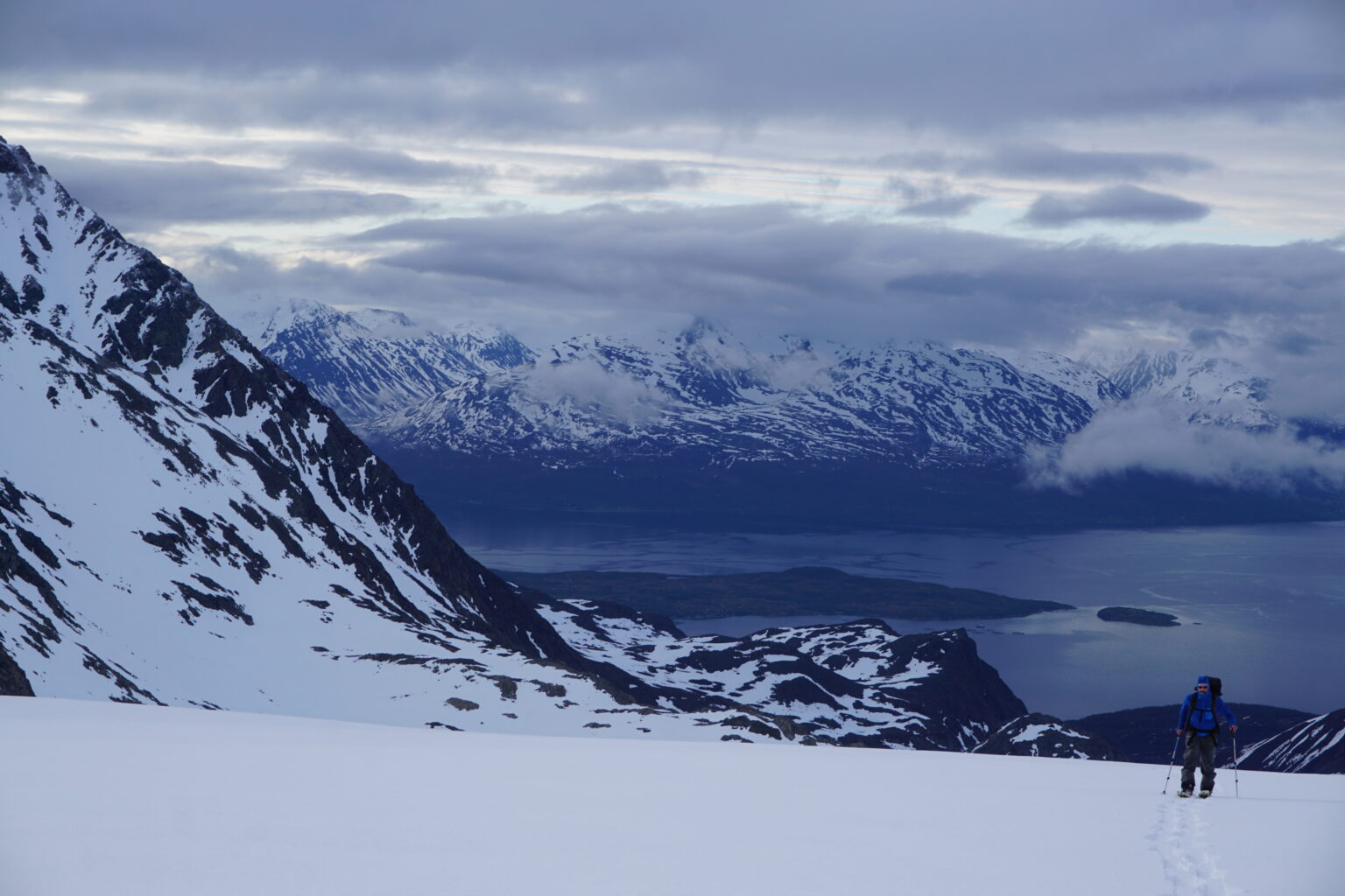 Ski touring up Strupbeen Glacier with the Lyngen Fjord in the distance