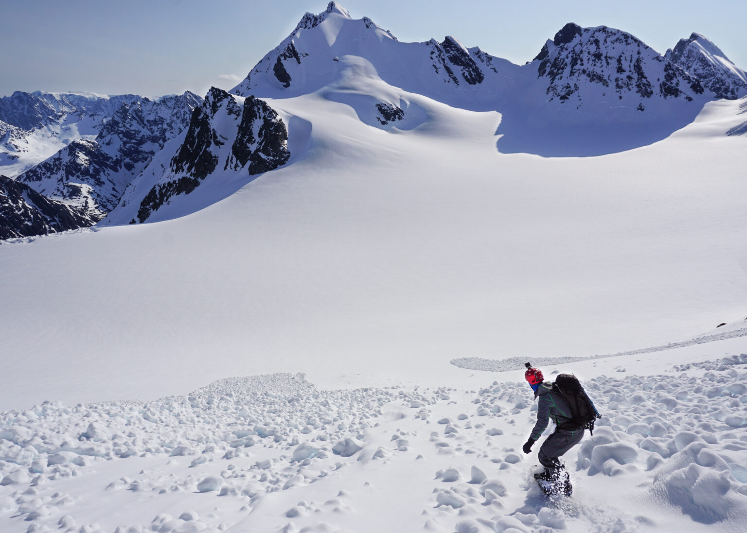 Snowboarding in the Lyngen Alps of Norway with Tvillingtinden in the background