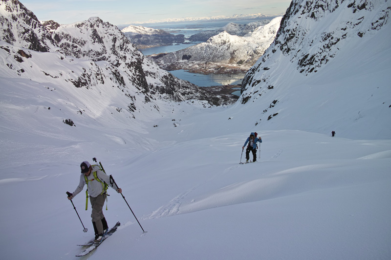 Ski touring up with the Lofoten Islands in the distance