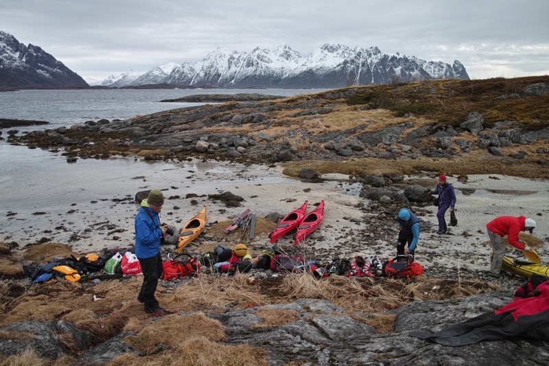 Getting our gear into the sea Kayaks before exploring the Trollfjord in the Lofoten Islands of Norway