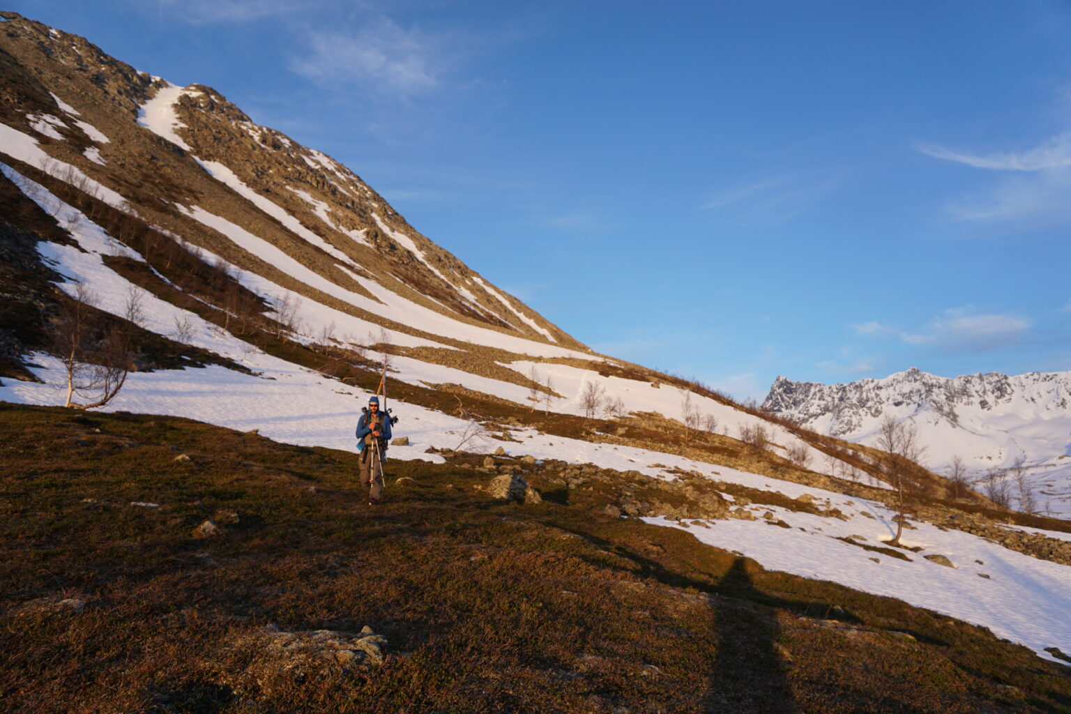 Hiking back towards camp with the south gully of Veidalsfjellet in the distance