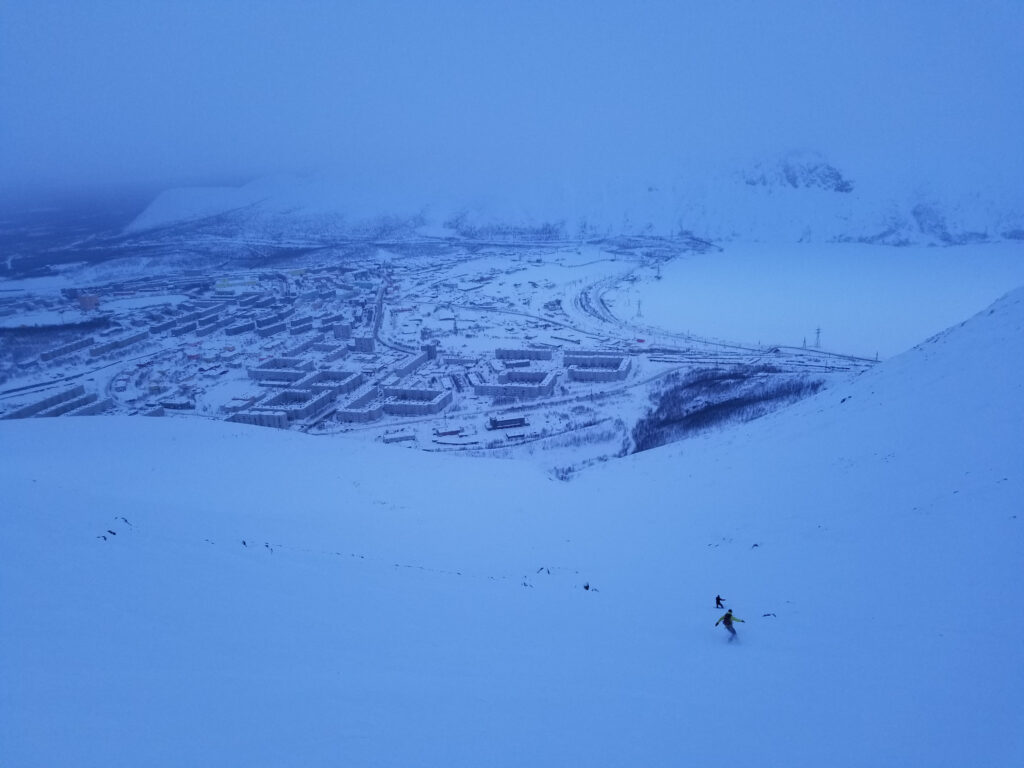 Snowboarding Big Wood sidecountry with Kirovsk in the background