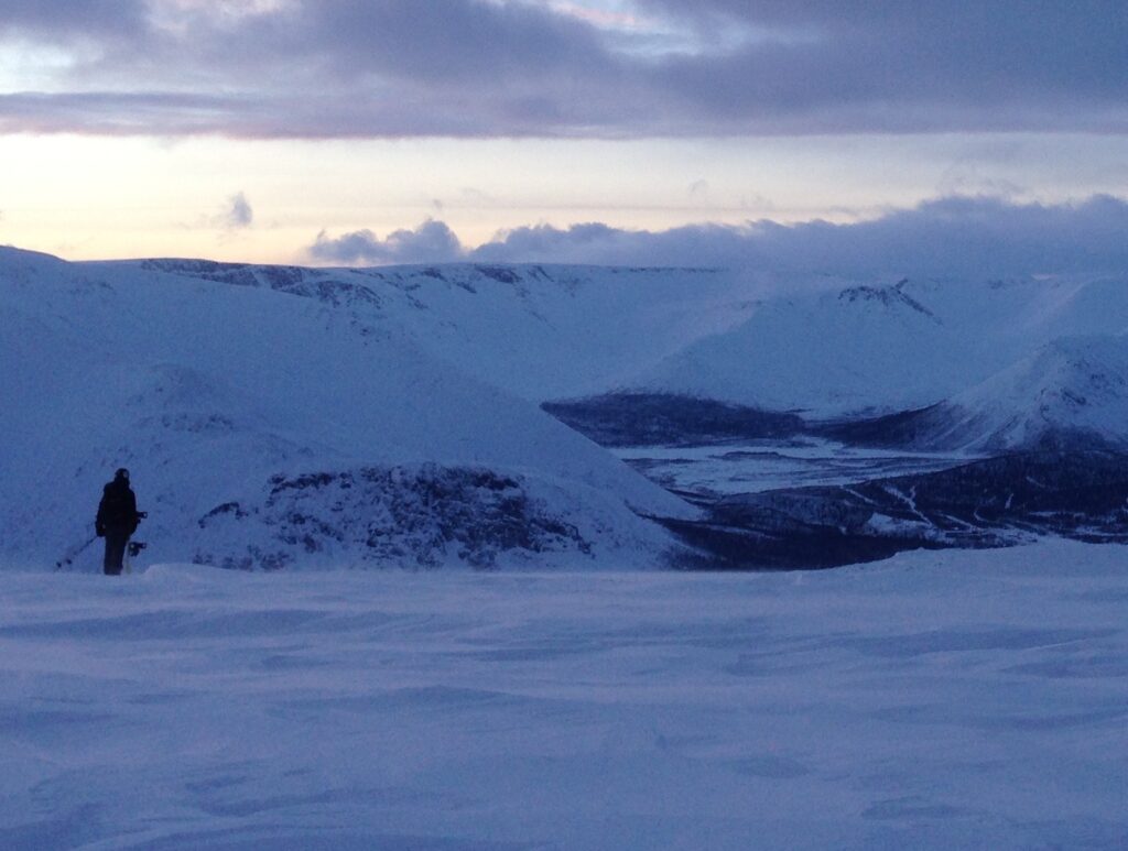 Preparing to snowboard down with the Khibiny Mountains in the distance