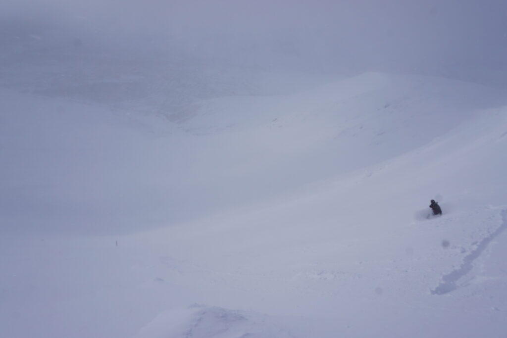 Snowboarding down the sidecountry bowl at Bigwood ski center