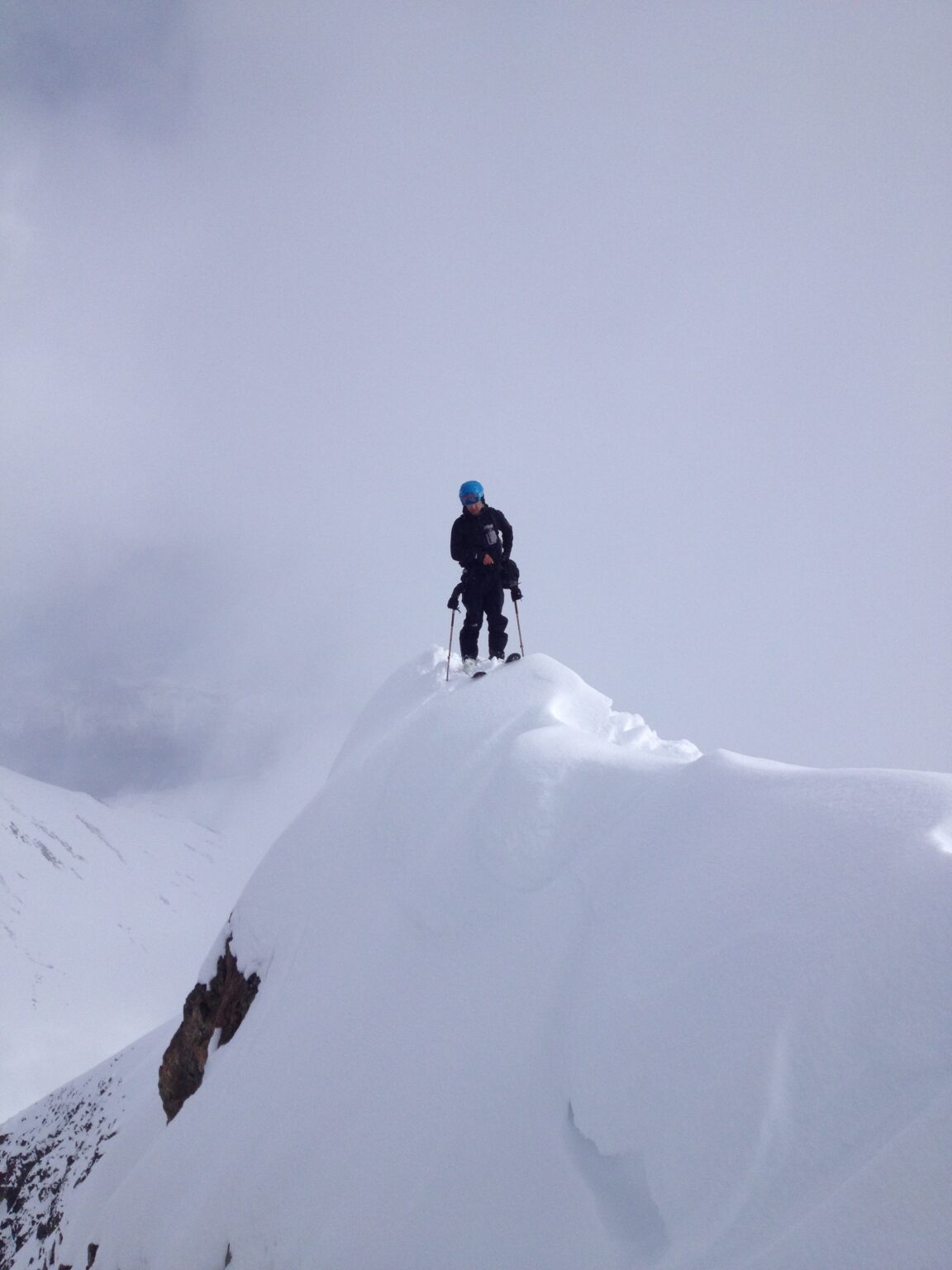 Standing on a steep ridge before riding down to Kvalvikdalen Valley