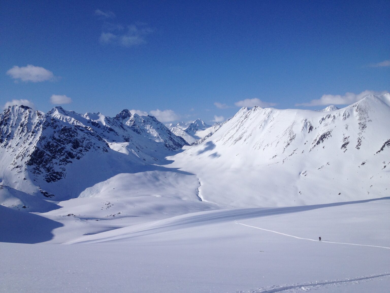 Ski touring up Rundsfjellet with the Kvalvikdalen Valley in the distance