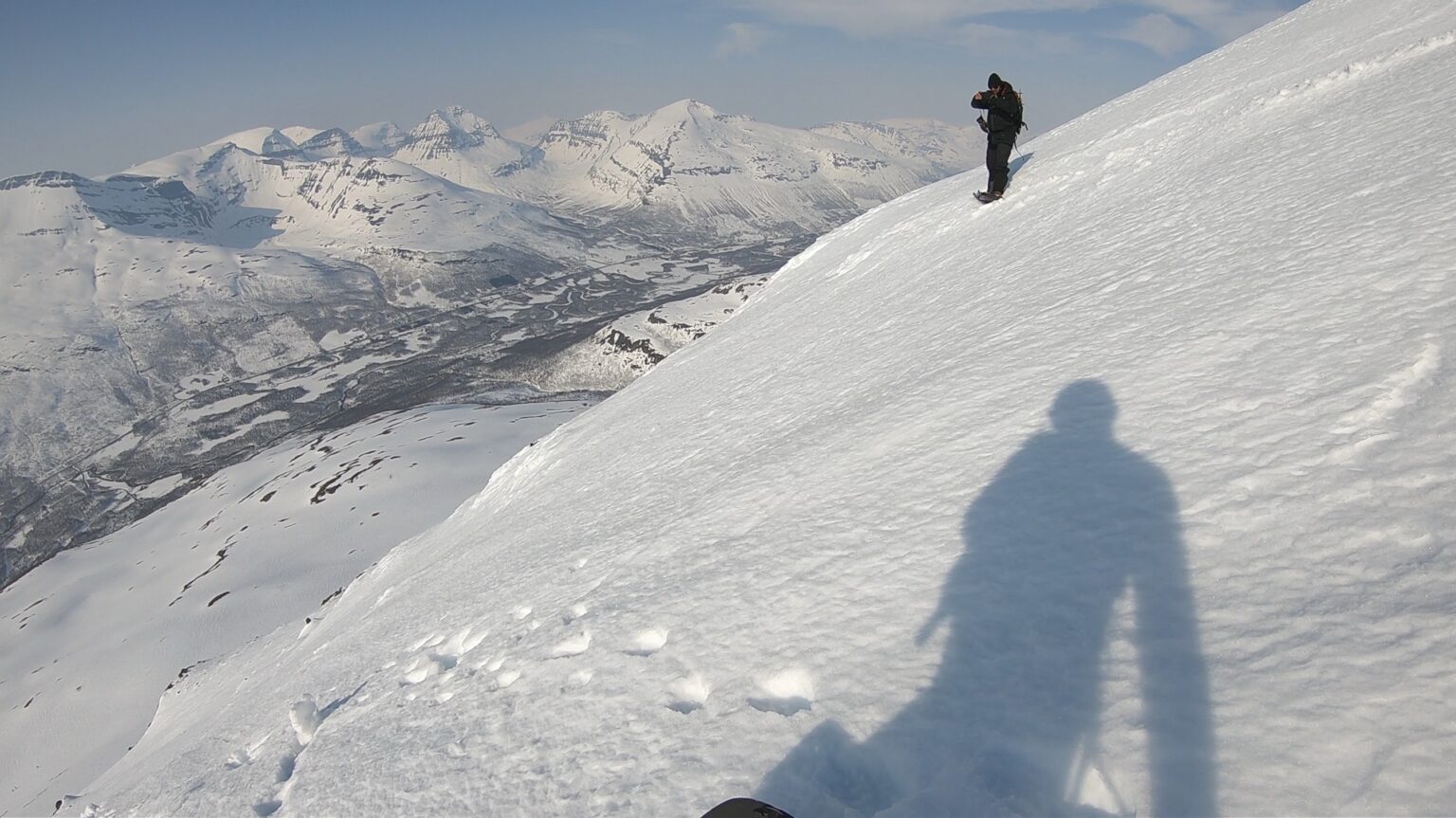 Preparing to snowboard down the North face of Rostakulen