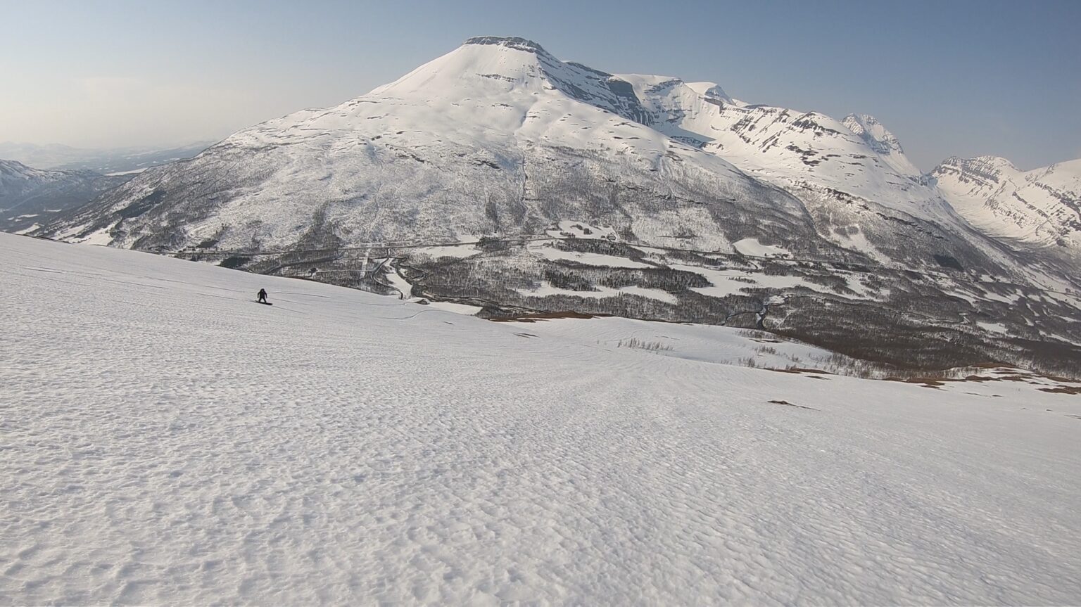 Snowboarding down the upper slopes