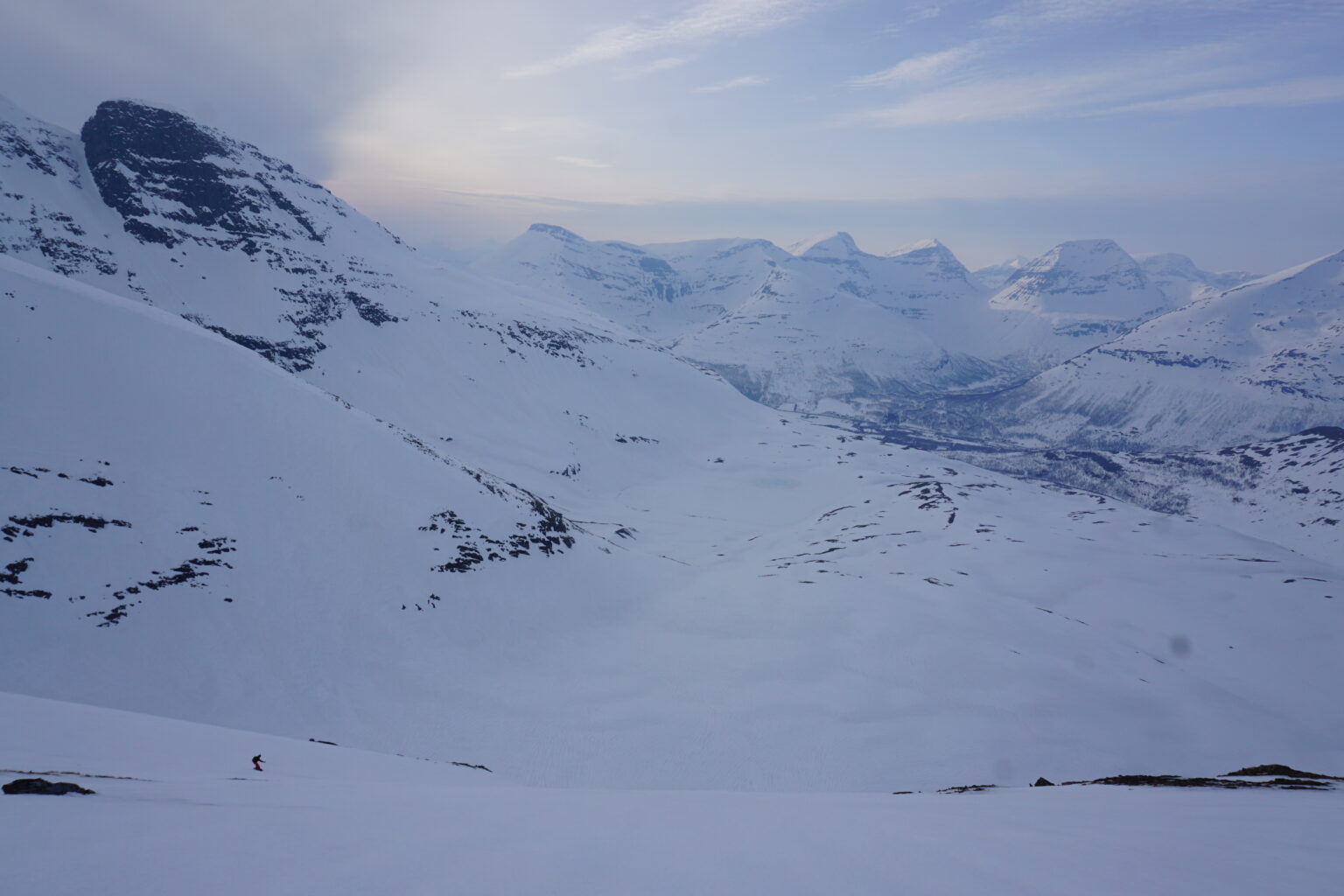 Making snowboard turns down while on the Melkefjellet and Istinden Ridge Traverse