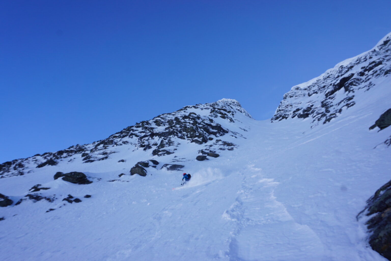 Looking back up while a friend skis the upper portion of the Morning Mission